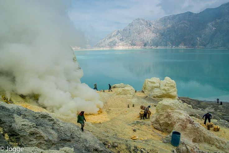 Volcanic crater of Mount Ijen lit by eerie blue flames before sunrise
