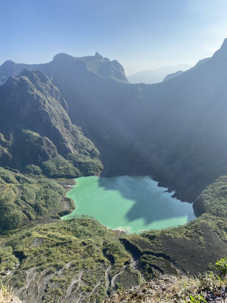 Panoramic shot of Kelud volcano crater lake surrounded by rugged terrain