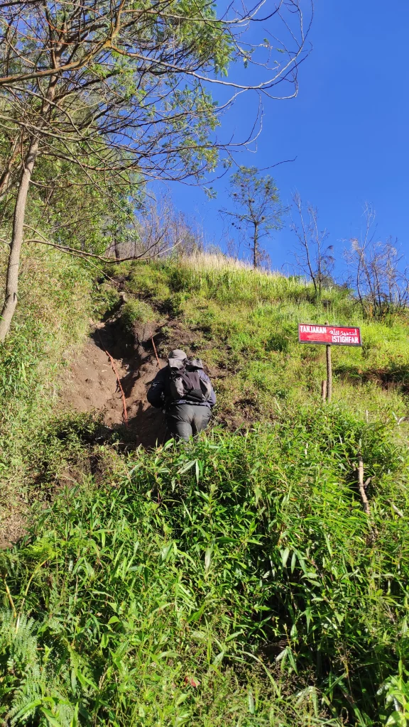 Pendaki menapaki jalur ekstrem Gunung Kawi menuju Puncak Batu Tulis dengan panorama awan