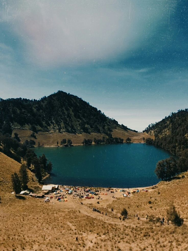 Camp at Ranu Kumbolo lake with Mount Semeru towering behind—an iconic scene from one of the best mountains in East Java for adventure seekers.