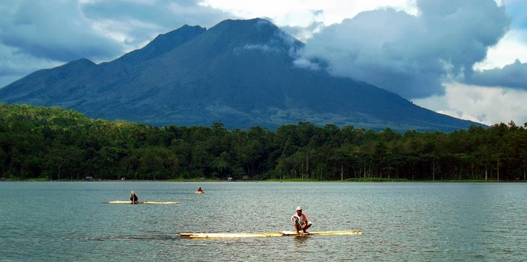 Symmetrical volcanic dome of Mount Lemongan rising above lush East Java landscape